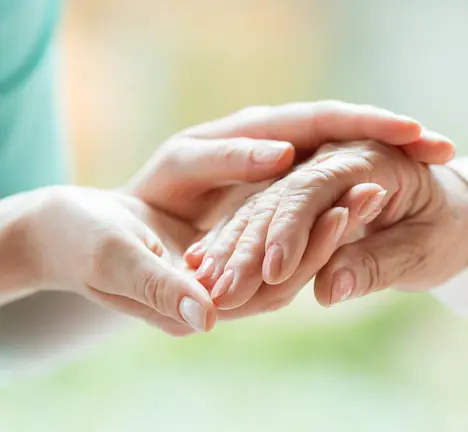 Senior person thanking the nurse for her help during a meeting in a nursing home
