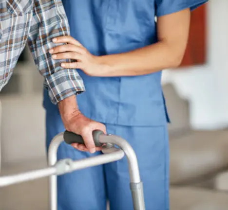Shot of a woman assisting her elderly patient who's using a walker for support
